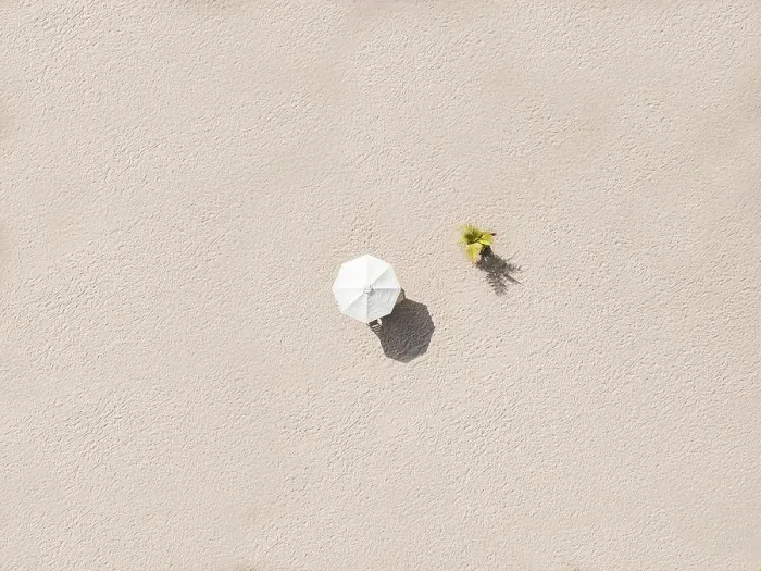 Framed Print : Aerial view of single beach umbrella on sandy beach