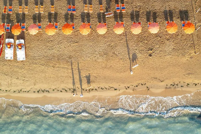 Framed Print : Aerial view of sunshades in a row on sand beach washed by the crystal sea
