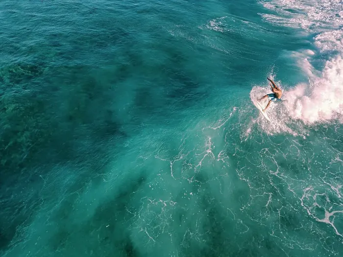 Framed Print : Aerial view of surfer on a wave