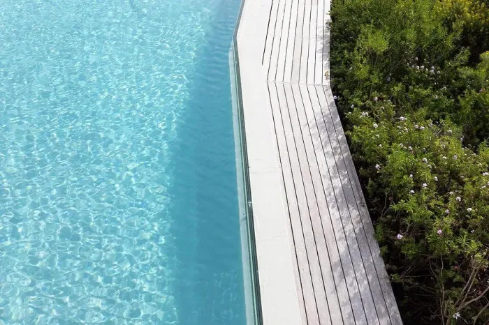 Framed Print : Aerial view of a swimming pool with a paved edge and plants in a garden