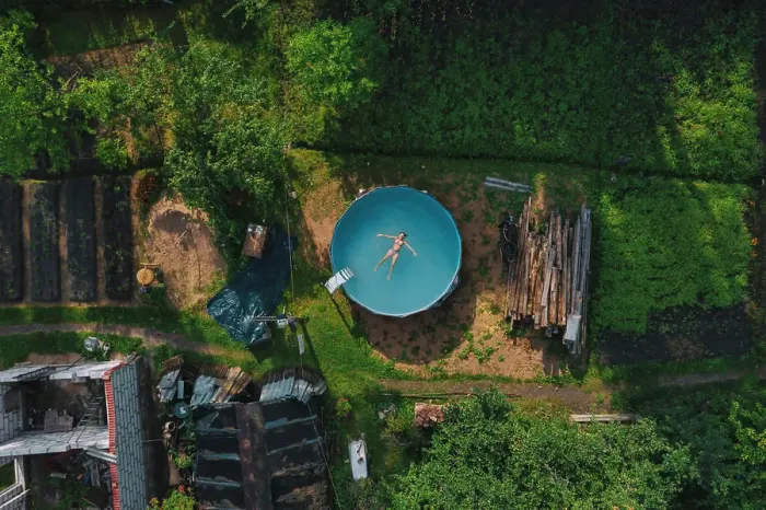 Framed Print : Aerial view of woman floating over water at pool Framed Print : Aerial view of woman floating over water at pool