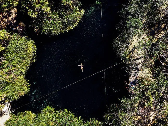 Framed Print : Aerial view of woman swimming in cenote Framed Print : Aerial view of woman swimming in cenote