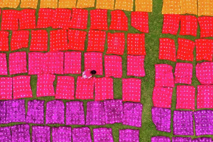 Framed Print : Aerial view of a woman working placing colourful towels in a field near Araihazar, Dhaka district, Bangladesh Framed Print : Aerial view of a woman working placing colourful towels in a field near Araihazar, Dhaka district, Bangladesh