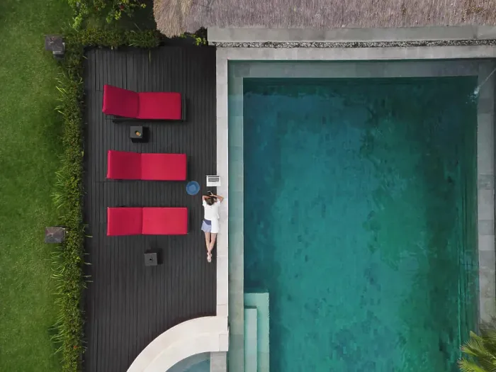 Framed Print : Aerial view young woman with laptop near pool