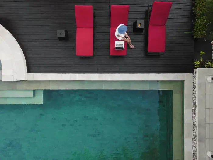 Framed Print : Aerial view young woman with laptop near pool Framed Print : Aerial view young woman with laptop near pool