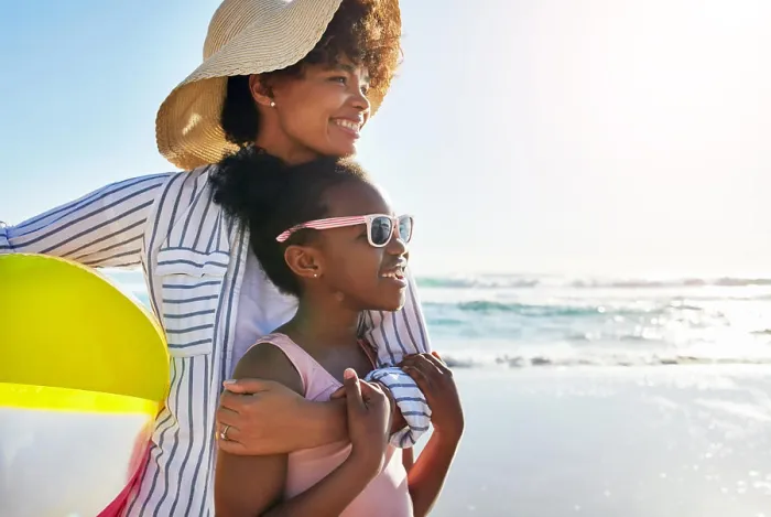 Framed Print : African mom, girl and hug on beach for holiday