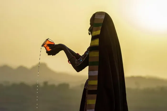 Framed Print : Ahir Woman in traditional colorful cloth pouring water at sunset, Great Rann of Kutch Desert, Gujarat, India, Asia Framed Print : Ahir Woman in traditional colorful cloth pouring water at sunset, Great Rann of Kutch Desert, Gujarat, India, Asia