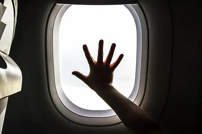 Framed Print : Aircraft window and hand of a child Framed Print : Aircraft window and hand of a child