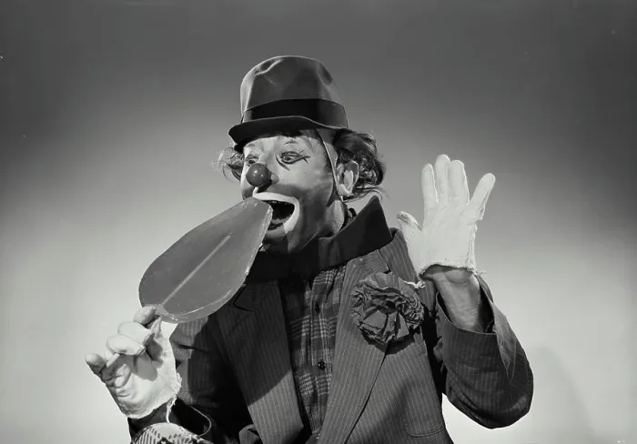 Framed Print : Alfred Ward Model Released. Vintage Photograph. Hobo clown taking bite of oversized large lollipop