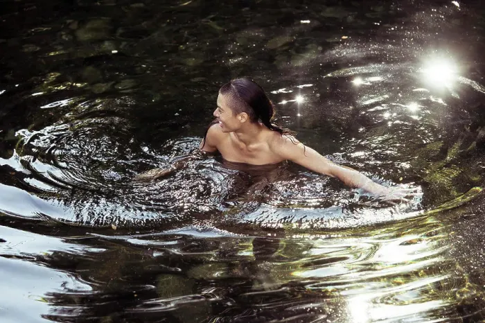 Framed Print : Androgynous young person wading in luscious water Framed Print : Androgynous young person wading in luscious water