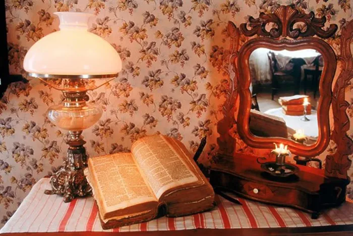 Framed Print : Antique wooden bureau with Bible, lamplight and mirror reflecting candle and old bedroom interior in Sweden Framed Print : Antique wooden bureau with Bible, lamplight and mirror reflecting candle and old bedroom interior in Sweden