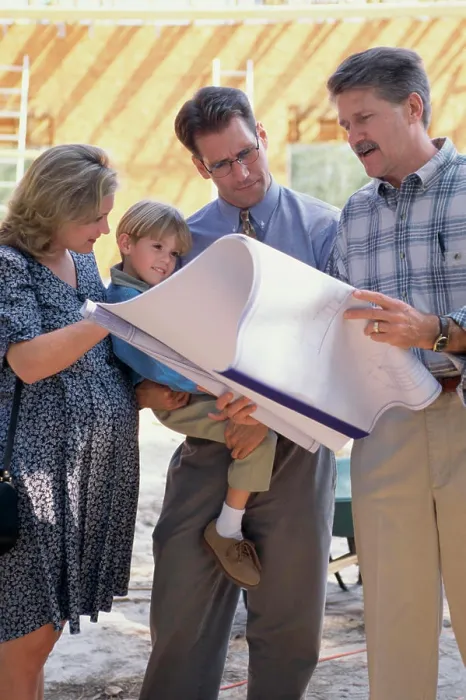 Framed Print : Architect discussing blueprints with a family Framed Print : Architect discussing blueprints with a family