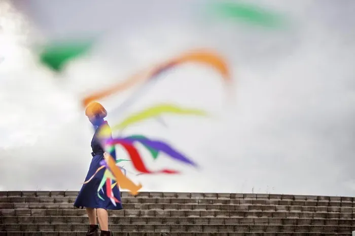 Framed Print : An artist during a performance moving a line of flags or streamers Framed Print : An artist during a performance moving a line of flags or streamers
