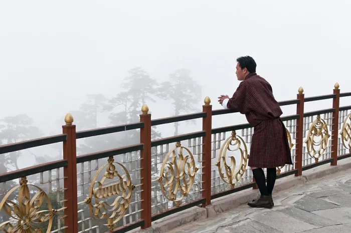 Framed Print : Asia, Bhutan, Dochu La. Man wearing traditional Gho garb looking into fog-shrouded trees. (MR) Framed Print : Asia, Bhutan, Dochu La. Man wearing traditional Gho garb looking into fog-shrouded trees. (MR)