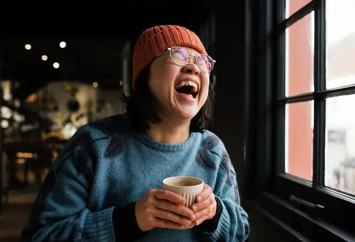 Framed Print : Asian woman laughing having coffee in a cafe Framed Print : Asian woman laughing having coffee in a cafe