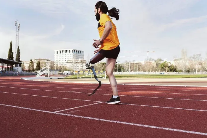 Framed Print : Athlete with prosthetic leg warming up on running track Framed Print : Athlete with prosthetic leg warming up on running track