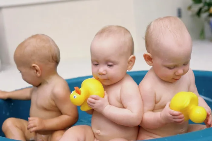 Framed Print : Three baby boys playing with rubber ducks