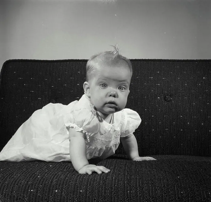 Framed Print : Baby girl crawling on a couch Framed Print : Baby girl crawling on a couch