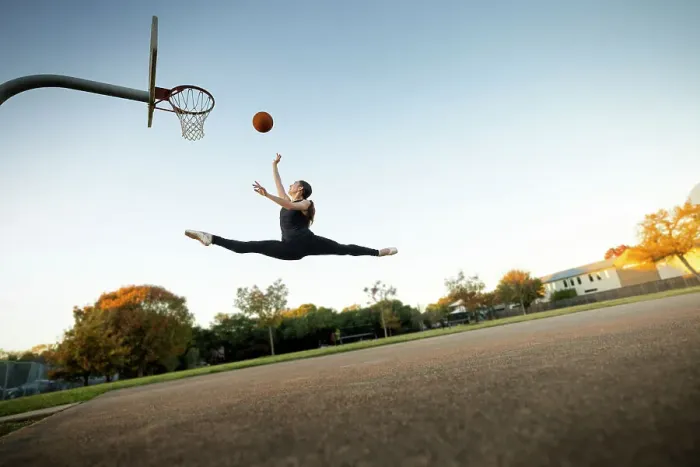 Framed Print : Ballet dancer mid-air jumping playing basketball on an outdoor court