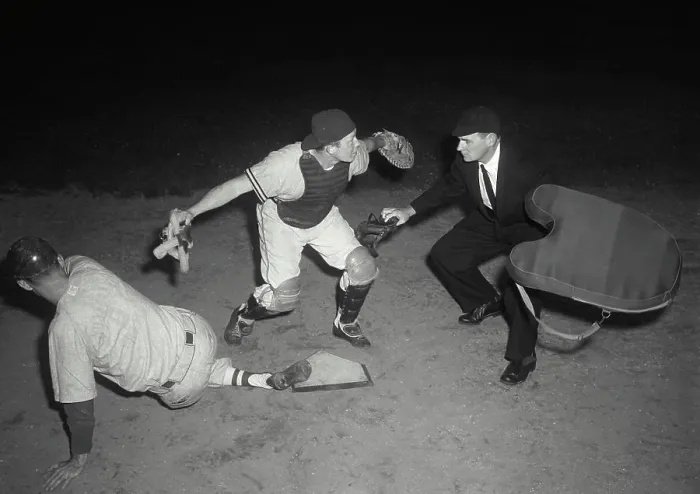 Framed Print : Baseball player sliding on home base and a umpire calling him safe Framed Print : Baseball player sliding on home base and a umpire calling him safe