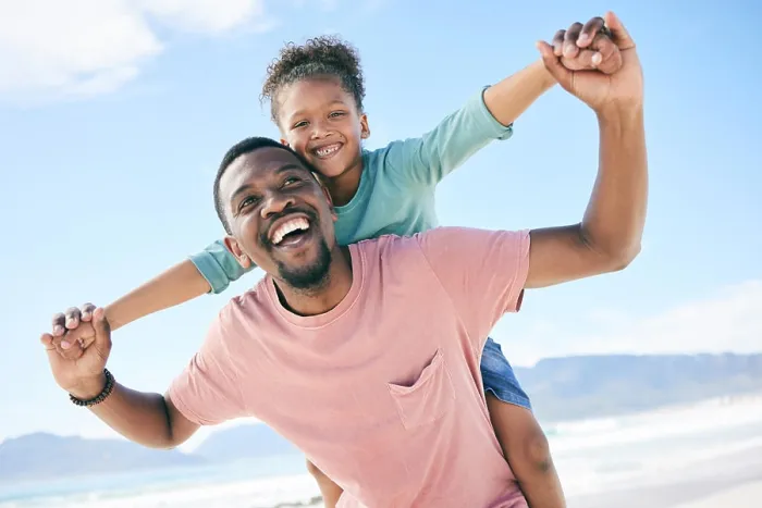 Framed Print : Beach, black man with child on piggy back and smile on playful family holiday in Australia with freedom and fun Framed Print : Beach, black man with child on piggy back and smile on playful family holiday in Australia with freedom and fun