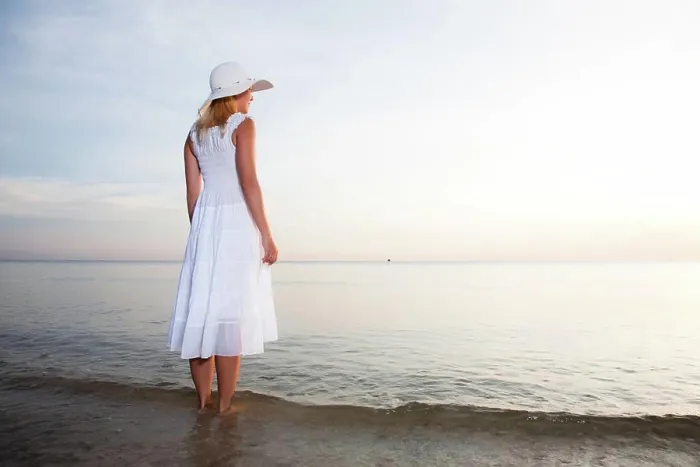Framed Print : On the beach Woman in hat and white dress on the beach
