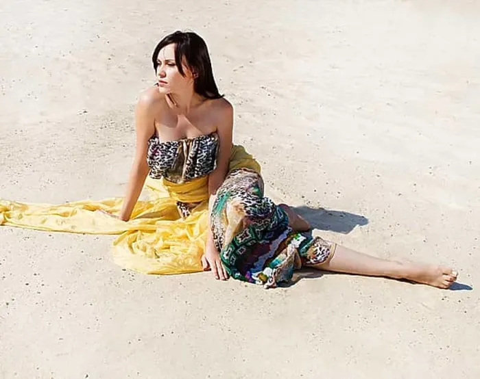 Framed Print : Beautiful woman on the beach sitting on the sand Framed Print : Beautiful woman on the beach sitting on the sand