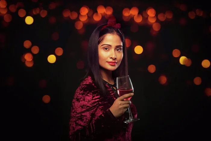 Framed Print : Beautiful woman holding a wine glass at a party Framed Print : Beautiful woman holding a wine glass at a party