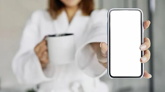 Framed Print : Beautiful woman showing blank phone. High resolution photo