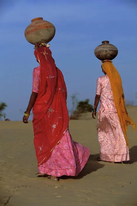 Framed Print : Bhil indigenous women carrying water jugs on their heads, Rajasthan Desert, India