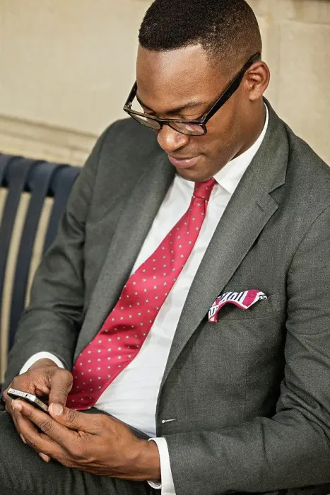 Framed Print : Black businessman using cell phone on bench Framed Print : Black businessman using cell phone on bench