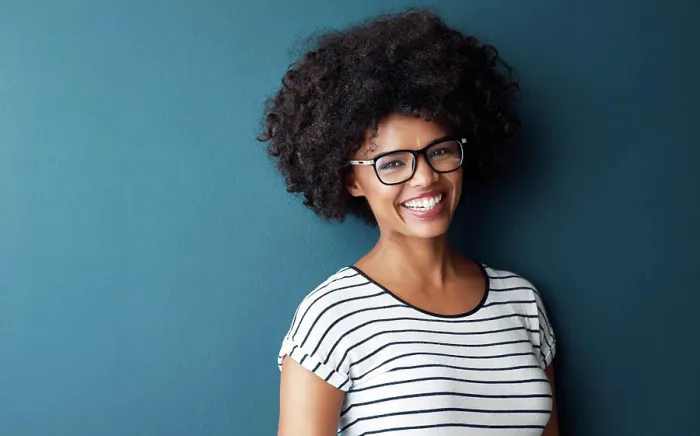 Framed Print : Black woman, portrait and smile with glasses for optometry or vision and on blue studio background