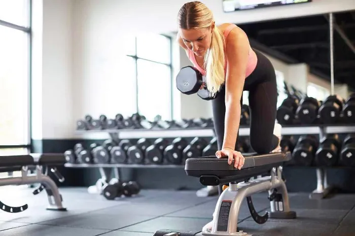 Framed Print : A blonde woman working out in a gym