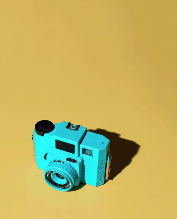 Framed Print : Blue Camera on Yellow Background