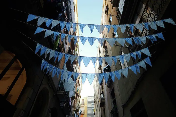 Framed Print : Blue garlands spanned across a street Framed Print : Blue garlands spanned across a street