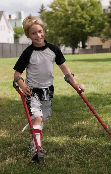 Framed Print : Boy with cerebral palsy walking with the support of crutches Framed Print : Boy with cerebral palsy walking with the support of crutches
