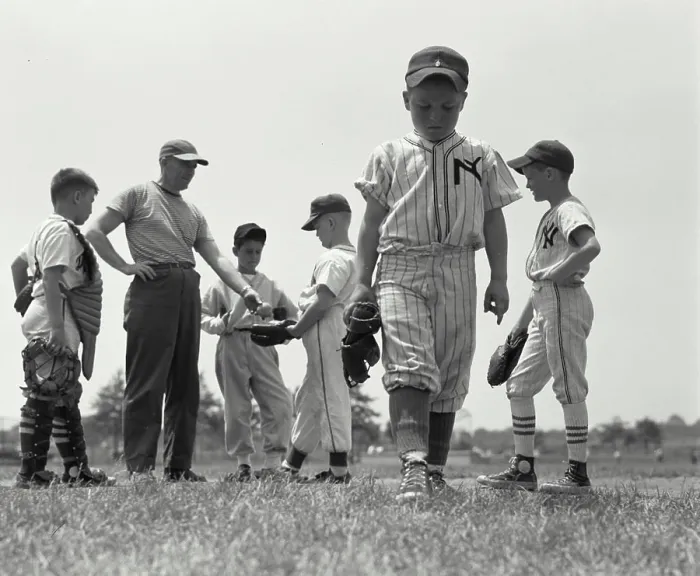 Framed Print : Boy expelled from youth league walking away from his team and coach Framed Print : Boy expelled from youth league walking away from his team and coach