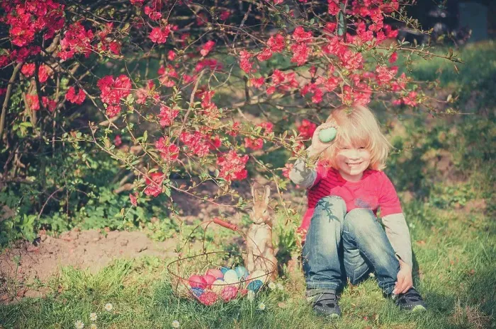 Framed Print : Boy in garden holding Easter egg