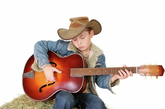 Framed Print : Boy strumming guitar A boy strums a tune on an acoustic guitar Framed Print : Boy strumming guitar A boy strums a tune on an acoustic guitar