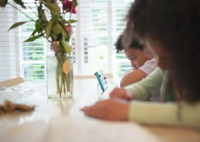 Framed Print : Boy with video game controller at table Framed Print : Boy with video game controller at table