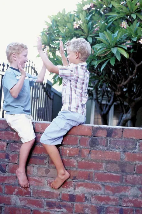 Framed Print : Boys playing on wall Framed Print : Boys playing on wall