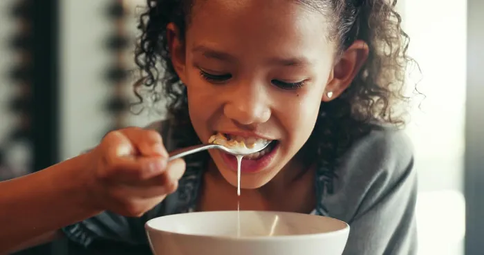 Framed Print : Breakfast, morning and eating with child and cereal at dining table for food Framed Print : Breakfast, morning and eating with child and cereal at dining table for food