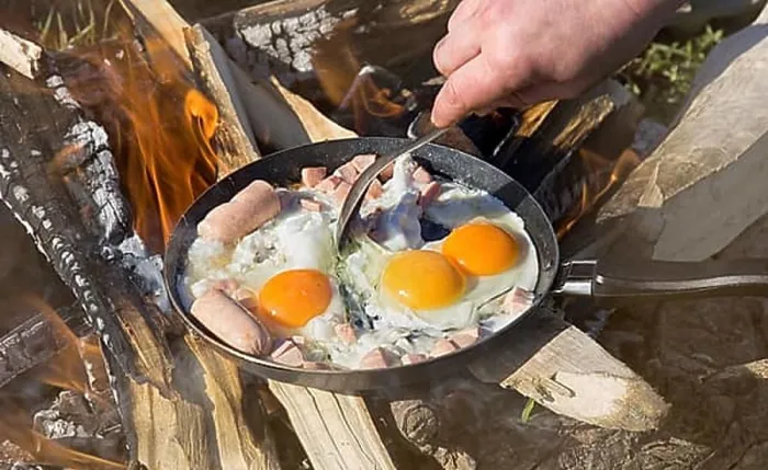 Framed Print : Breakfast on nature of a picnic. scrambled egg fried on coals in a pan on fire Framed Print : Breakfast on nature of a picnic. scrambled egg fried on coals in a pan on fire