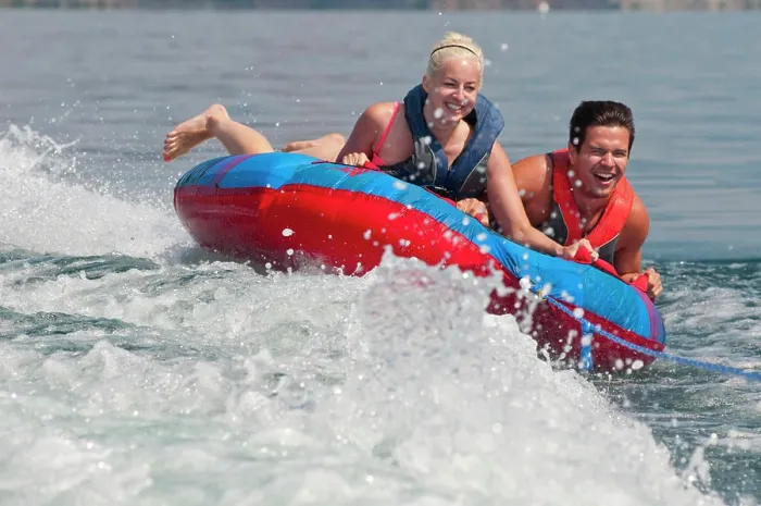 Framed Print : Brett and Kali laugh as they hold on tight to the tube as it is pulled behind the boat, on Kalamalka Lake, BC Framed Print : Brett and Kali laugh as they hold on tight to the tube as it is pulled behind the boat, on Kalamalka Lake, BC