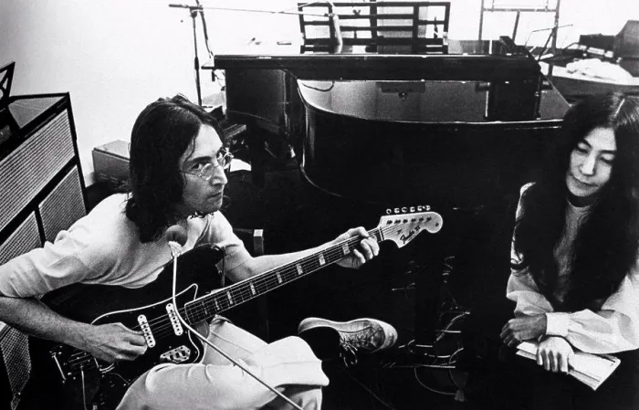 Framed Print : British singer, musician and member of The Beatles John Lennon playing guitar beside his wife Framed Print : British singer, musician and member of The Beatles John Lennon playing guitar beside his wife
