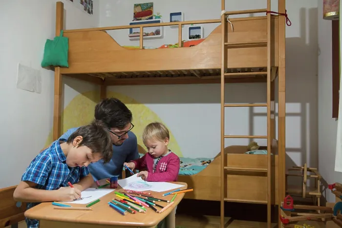 Framed Print : Brothers colouring with coloured pencils while father is assisting them, Munich, Germany Framed Print : Brothers colouring with coloured pencils while father is assisting them, Munich, Germany