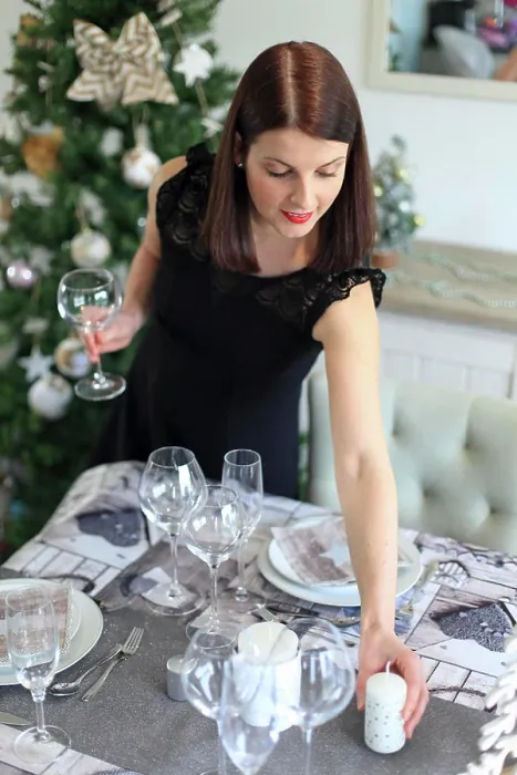 Framed Print : Brunette woman setting a table for Christmas Eve Framed Print : Brunette woman setting a table for Christmas Eve