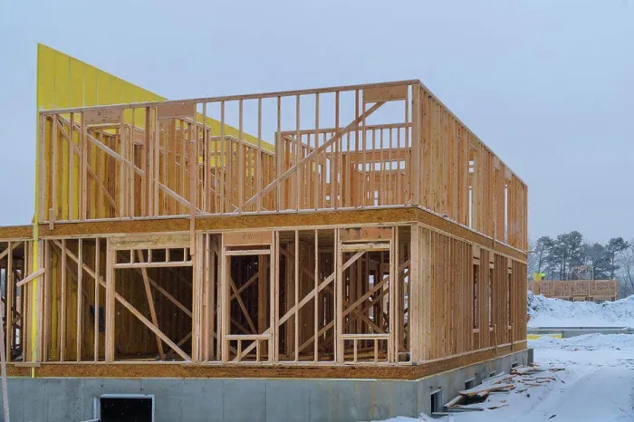Framed Print : Building frame structure on a new development timber frame for a progressing house Framed Print : Building frame structure on a new development timber frame for a progressing house