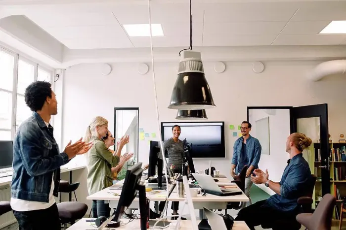 Framed Print : Business colleagues clapping for smiling speakers in office meeting Framed Print : Business colleagues clapping for smiling speakers in office meeting