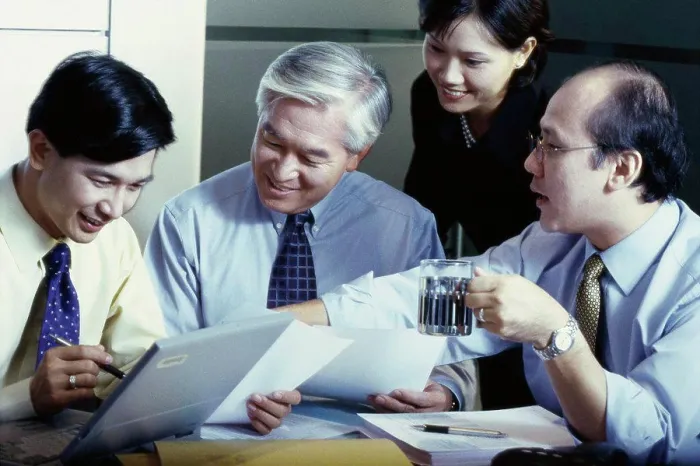 Framed Print : Business executives in a meeting